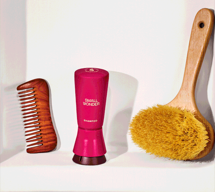Video of Hands pumping a small wonder shampoo bottle & lathering hands next to a comb and a brush.
