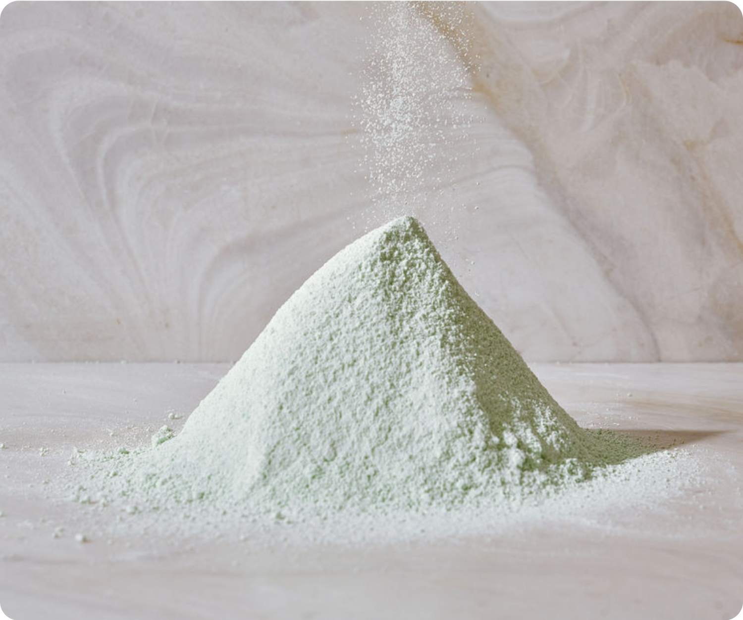 Pile of green powder on marble background