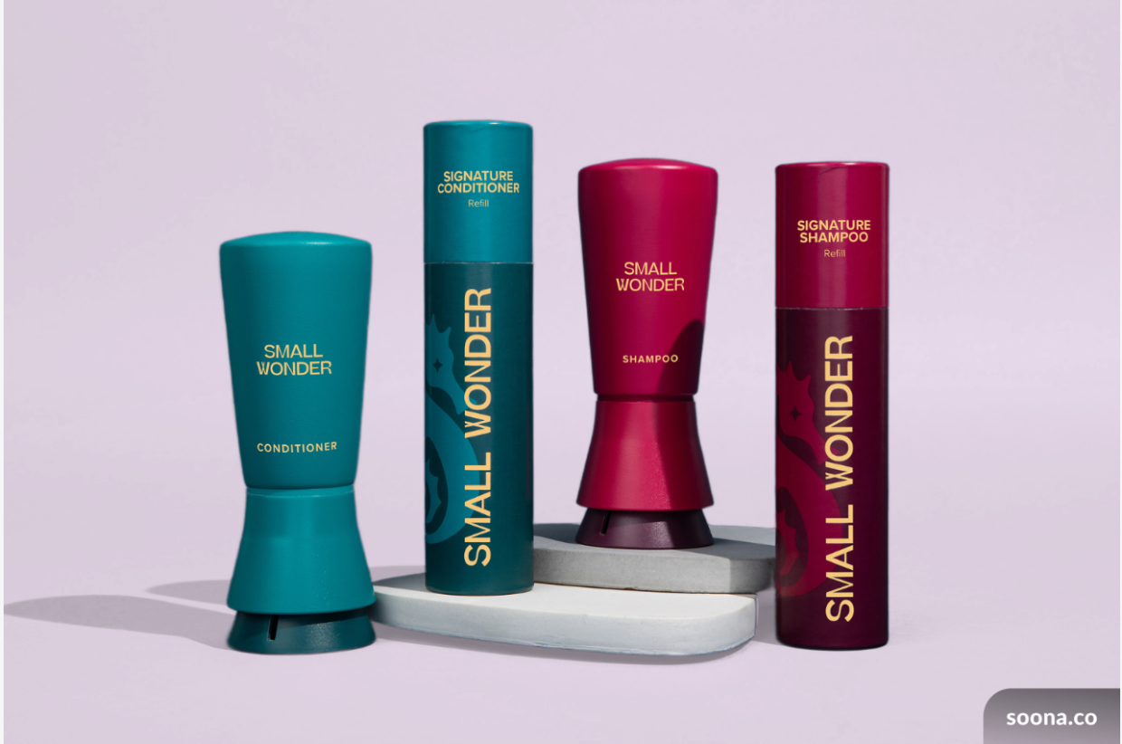 Two Small Wonder Signature shampoo and conditioner bottles and two refill bottles in teal and red.
