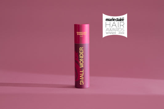 Small Wonder Signature Shampoo Refill Tube next to Marie Claire Hair Awards label