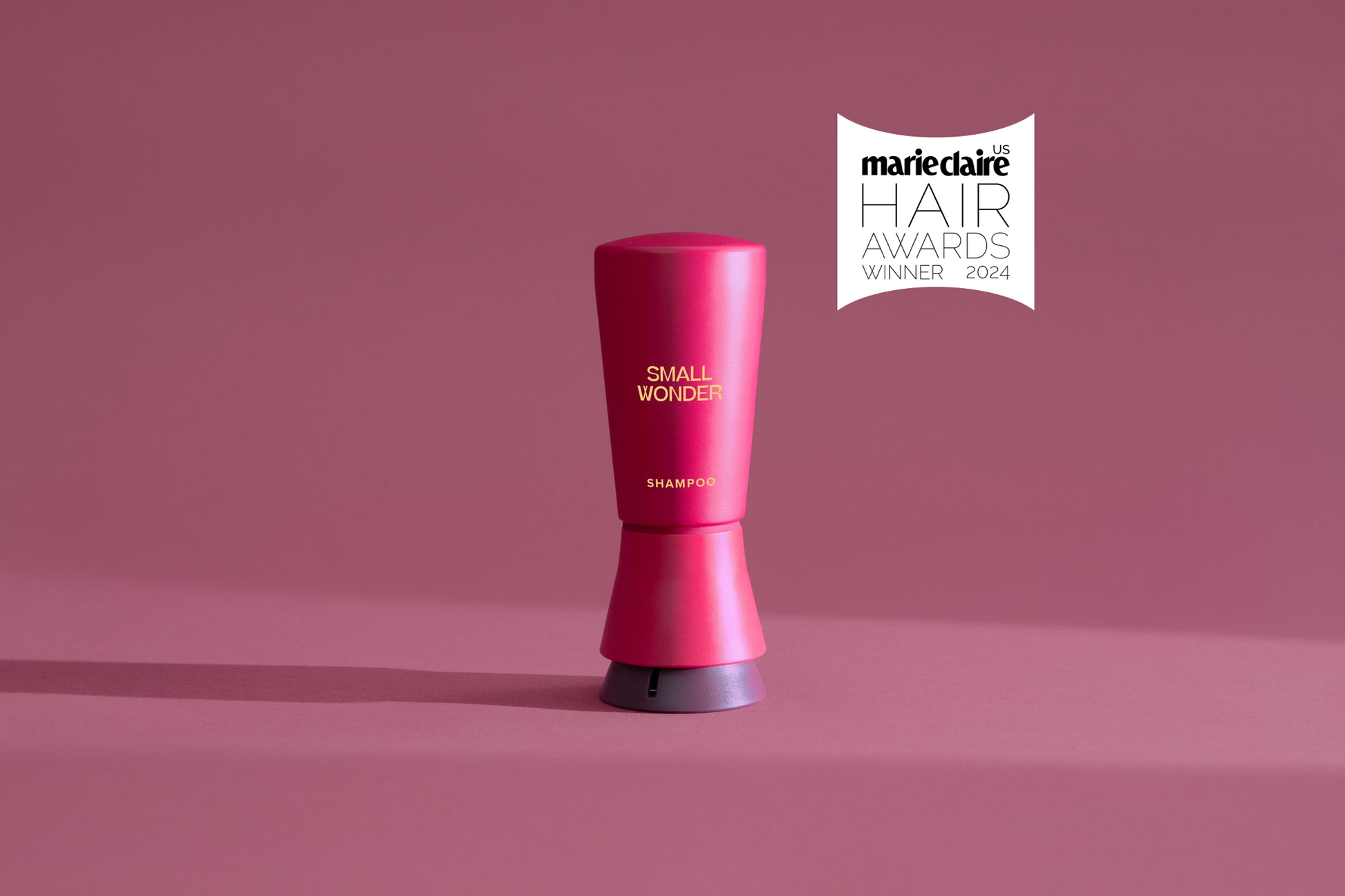 A red Small Wonder Shampoo bottle with a 2024 Marie Claire Hair Award Winner label