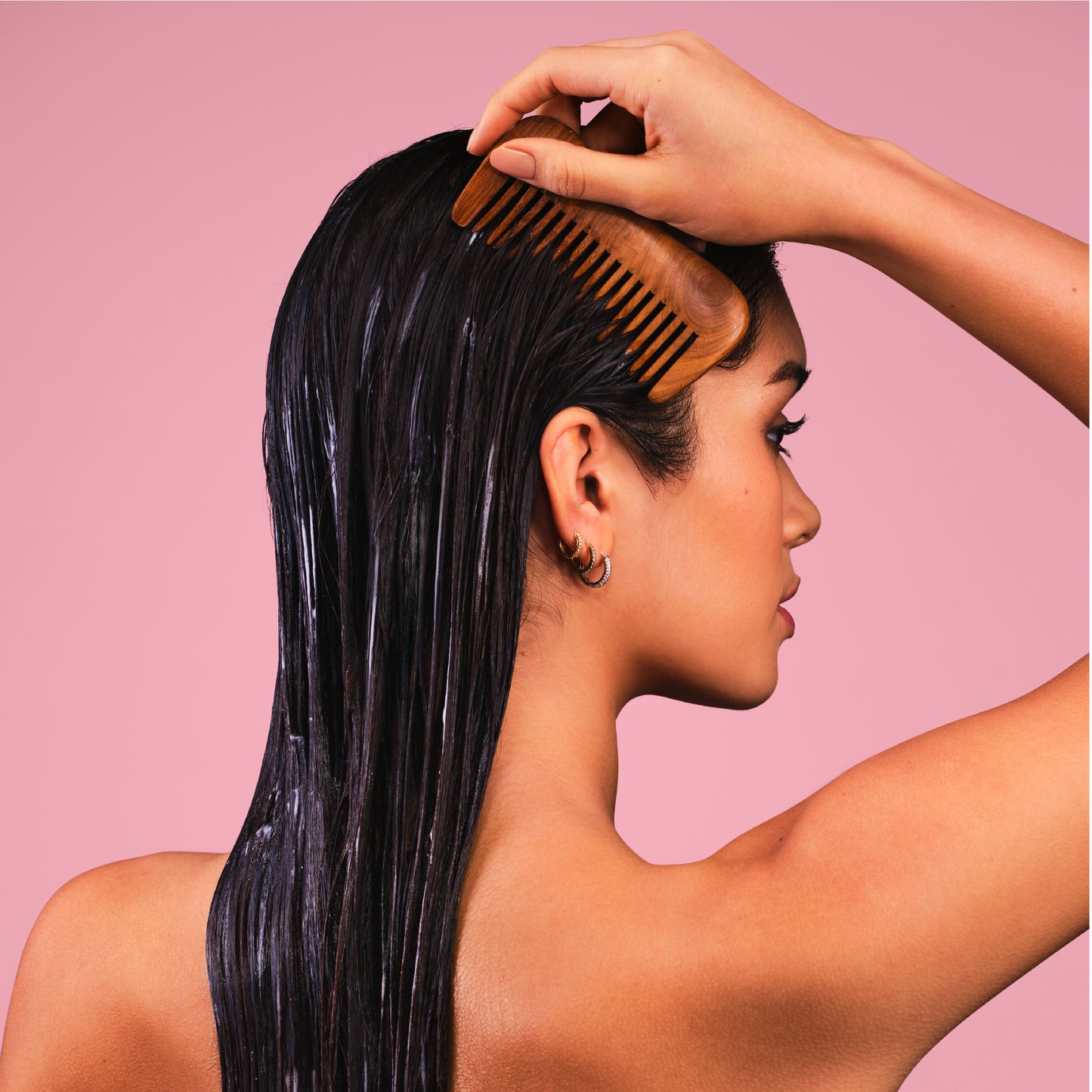 Woman combing lathered hair