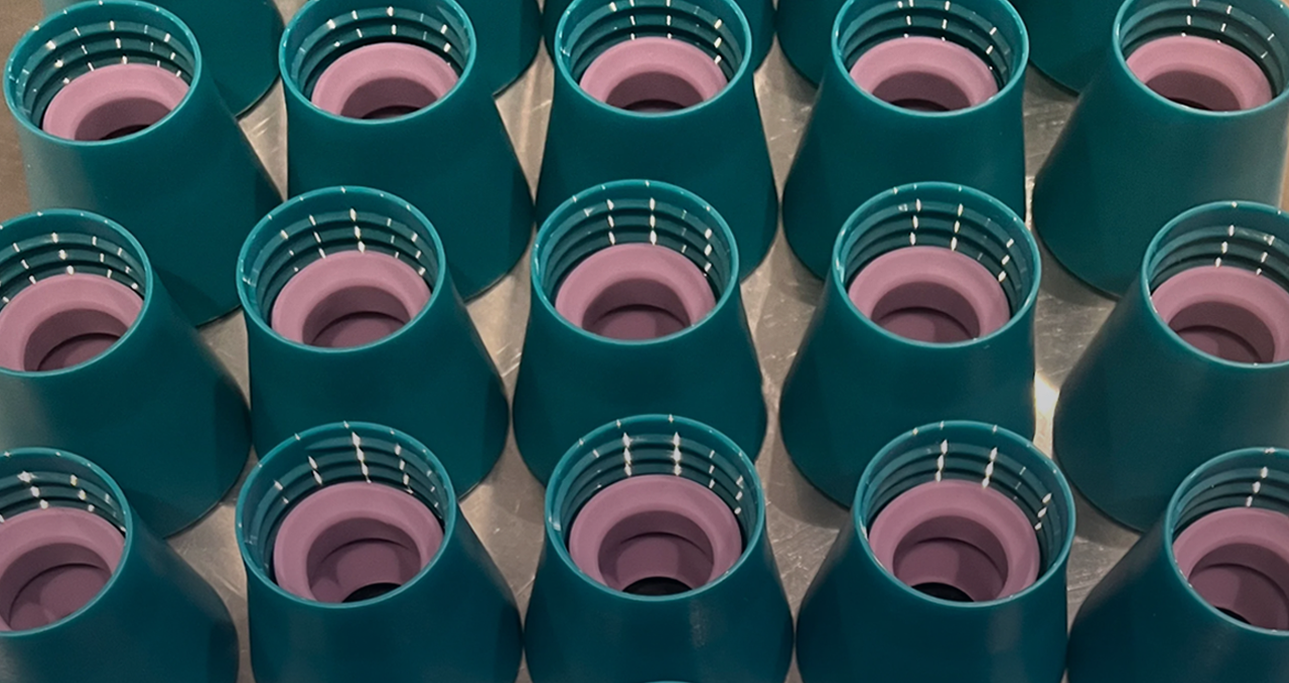 Caps of teal Small Wonder Conditioner bottles 