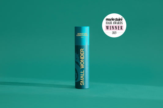 Small Wonder Signature Conditioner refill tube next to Marie Claire Har Awards 2025 Winner Label