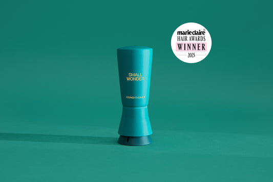 Small Wonder Signature Conditioner refill tube next to Marie Claire Har Awards 2025 Winner Label